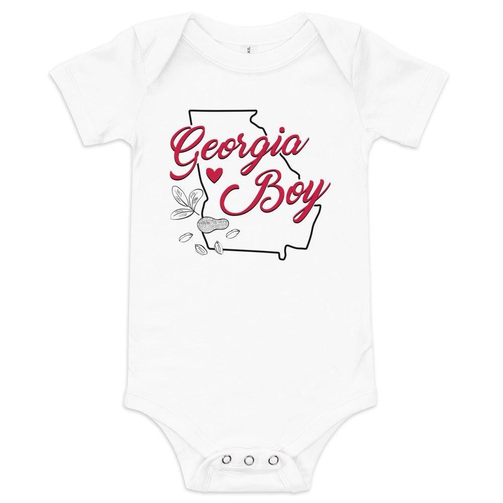 Baby onesie with "Georgia Boy" text in bold red and blue, featuring a peach graphic, on a white background.