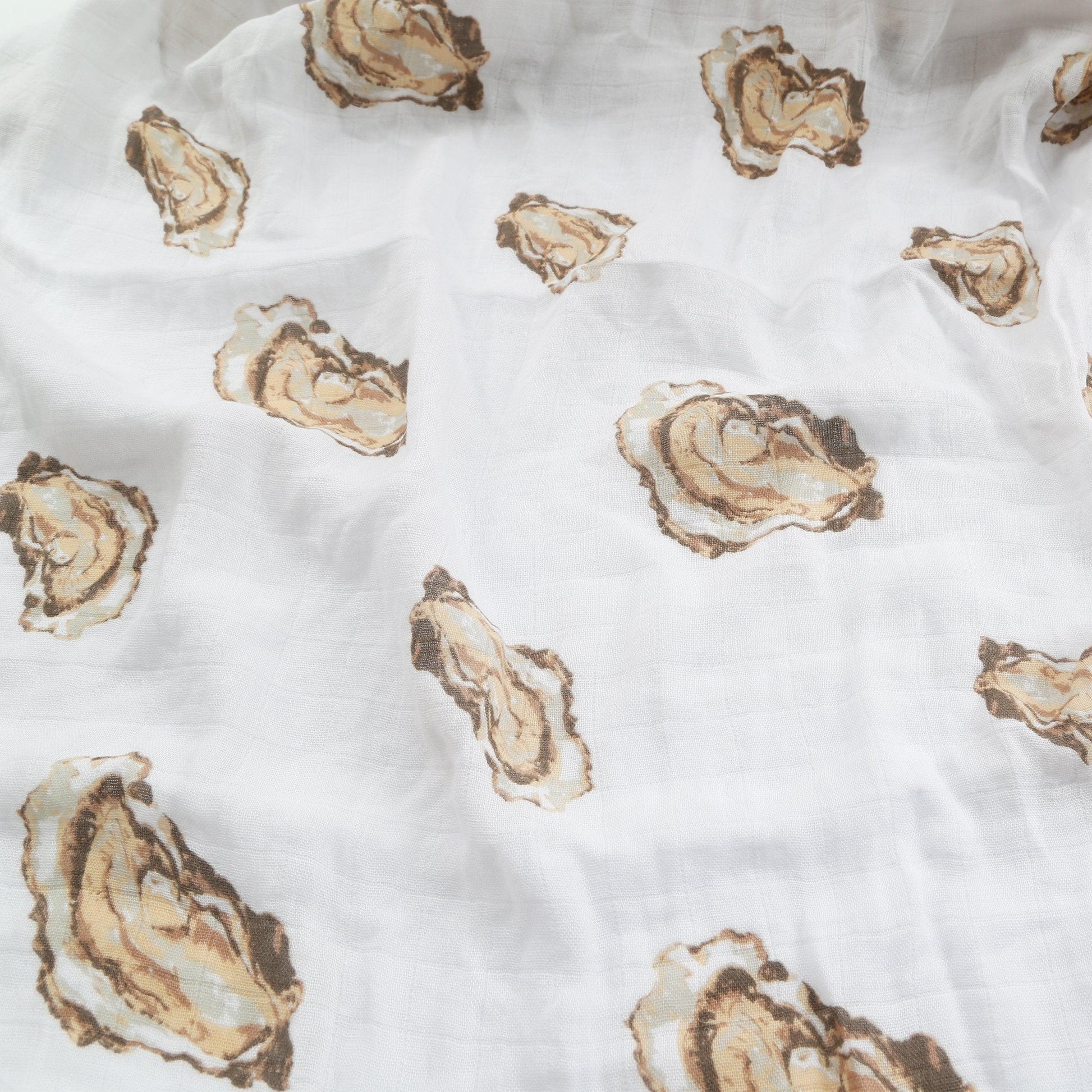 Baby gift set with oyster-themed muslin swaddle blanket and burp cloth/bib combo, featuring cute oyster illustrations.