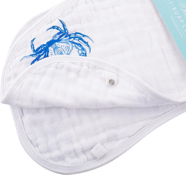 Blue crab-themed baby muslin swaddle blanket and burp cloth set, featuring playful crab illustrations on white fabric.