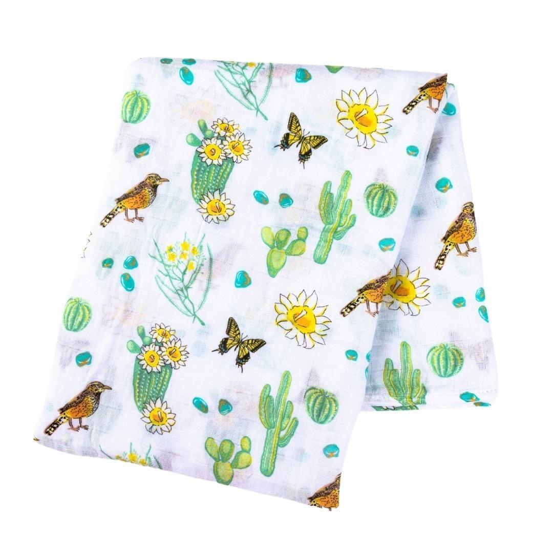 Cactus-themed baby muslin swaddle blanket and burp bib set, featuring vibrant green cacti on a white background.