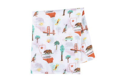 Gift set with a California Baby muslin swaddle blanket and burp cloth/bib combo, featuring a playful bear design.