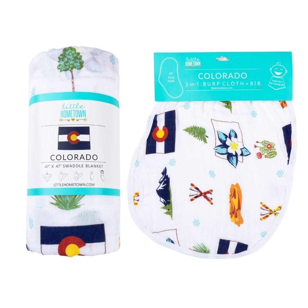 Colorado-themed baby gift set with muslin swaddle blanket and burp cloth, featuring mountains and wildlife.