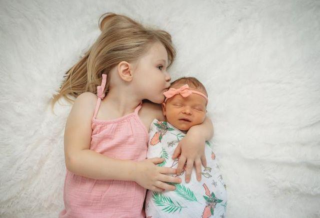 Floral-themed baby muslin swaddle blanket and burp cloth set, featuring vibrant pink and green flowers.