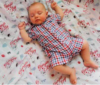 Gift set with Georgia Boy muslin swaddle blanket and burp cloth/bib combo, featuring state-themed designs.