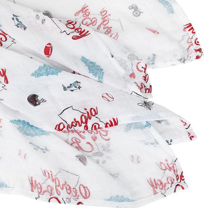 Georgia-themed muslin swaddle blanket and burp cloth set featuring peaches and state outline, neatly folded.