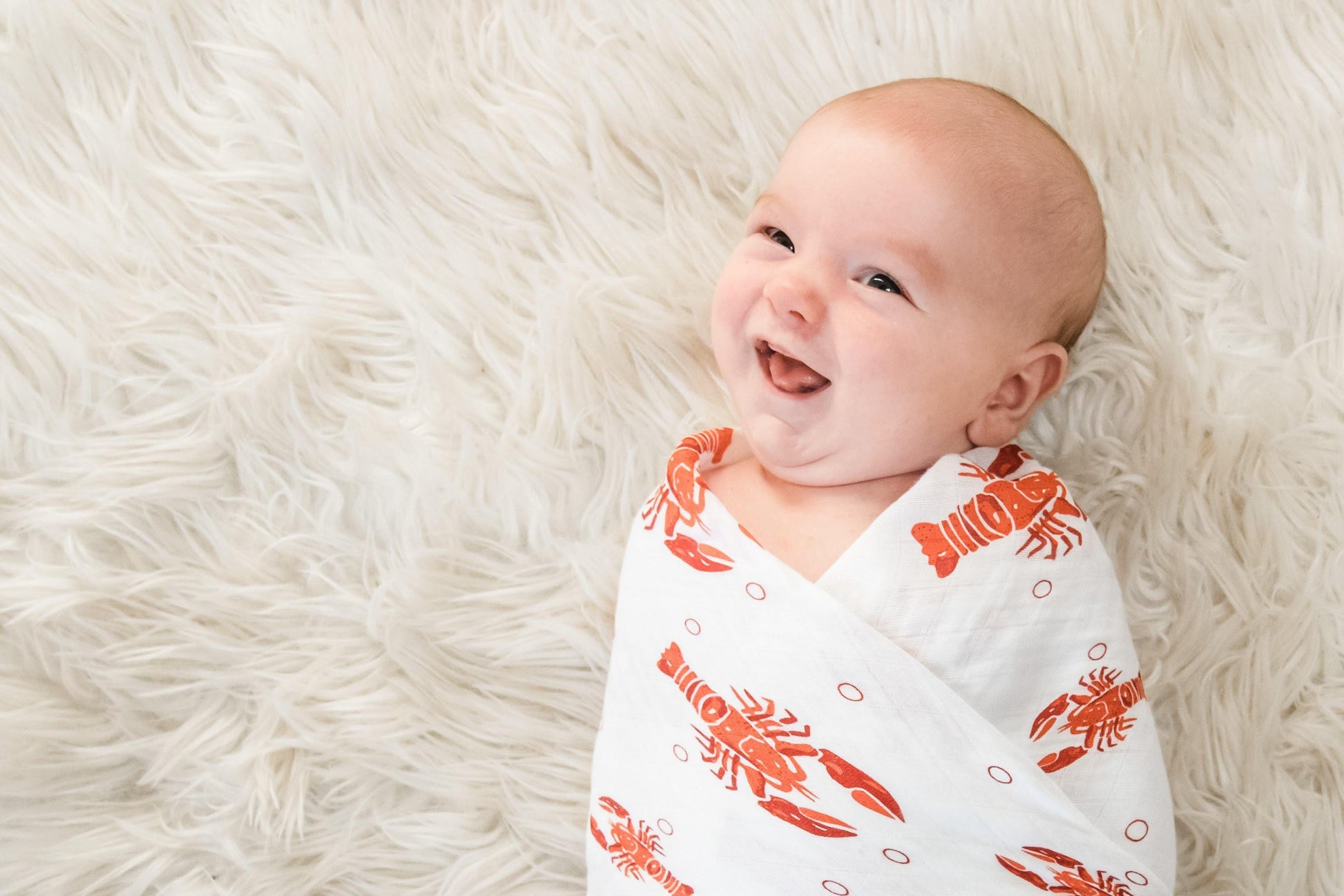 Gift set with a crawfish and lobster-themed muslin swaddle blanket and burp cloth/bib combo from Little Hometown.