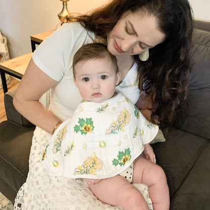 Floral-themed baby muslin swaddle blanket and burp cloth set, featuring delicate pink and green patterns.