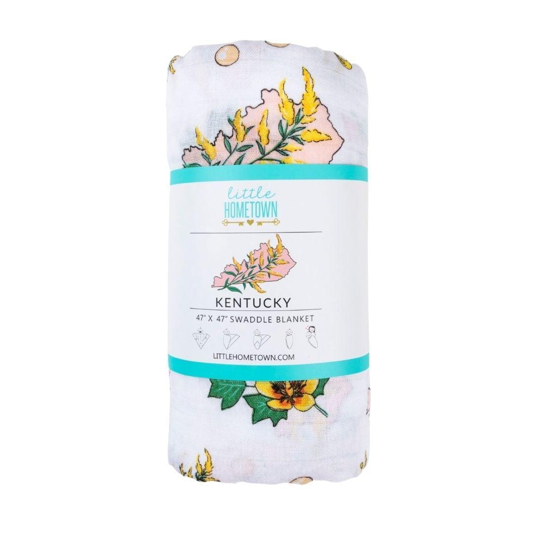 Floral-themed muslin swaddle blanket and burp cloth set, featuring delicate pink and green botanical patterns.
