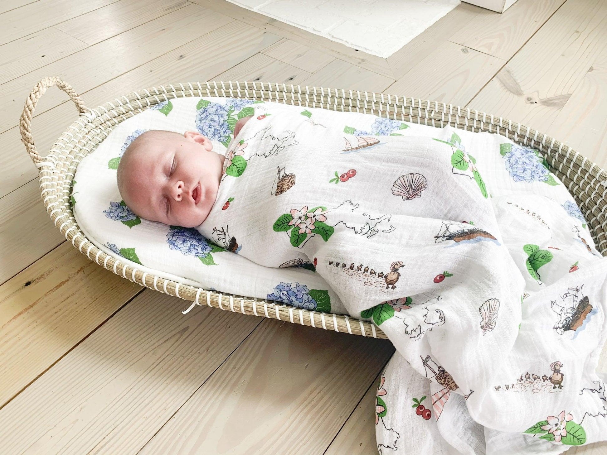 Massachusetts-themed baby swaddle and burp cloth set with floral designs, featuring state map and landmarks.