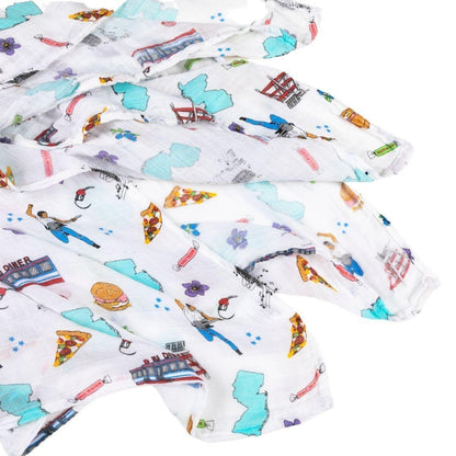 New Jersey-themed baby gift set with muslin swaddle blanket and burp cloth, featuring state icons and landmarks.