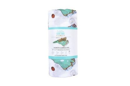 North Carolina-themed baby gift set with muslin swaddle blanket and burp cloth/bib combo, featuring state icons.