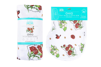 Ohio-themed baby gift set with floral muslin swaddle, receiving blanket, and burp bib, neatly arranged.