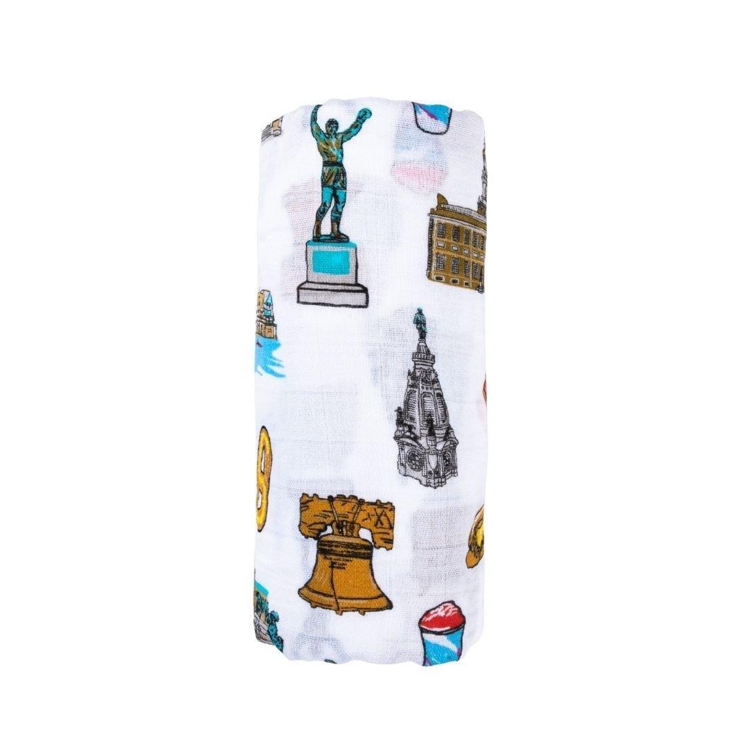 Philadelphia-themed baby gift set with muslin swaddle blanket and burp cloth, featuring iconic city landmarks.
