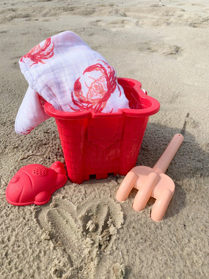 Pink crab-themed baby muslin swaddle blanket and burp cloth set, neatly folded on a white background.