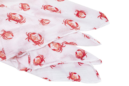Pink crab-themed baby muslin swaddle blanket and burp cloth set, neatly folded on a white background.