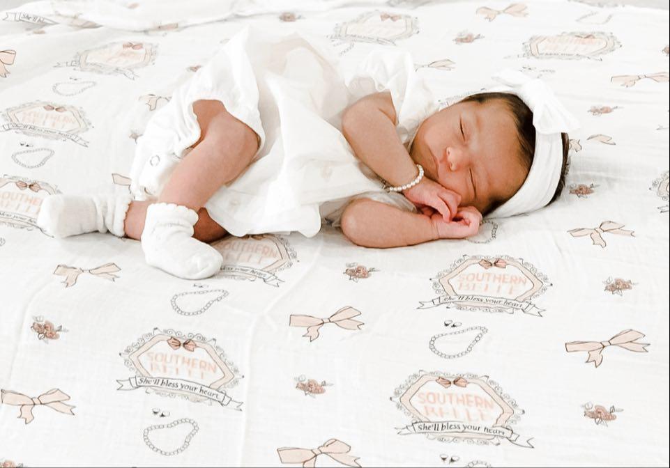Southern Belle baby muslin swaddle blanket and burp cloth set with floral patterns, neatly folded on a white background.