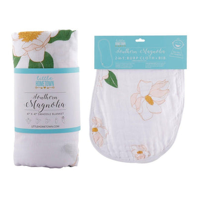 The Southern Magnolia gift set with a rolled swaddle and matching burp cloth and bib combo in blush.