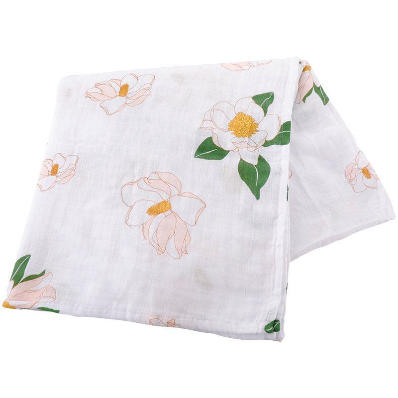 Southern Magnolia baby muslin swaddle blanket and burp cloth set, featuring delicate floral patterns on soft fabric.