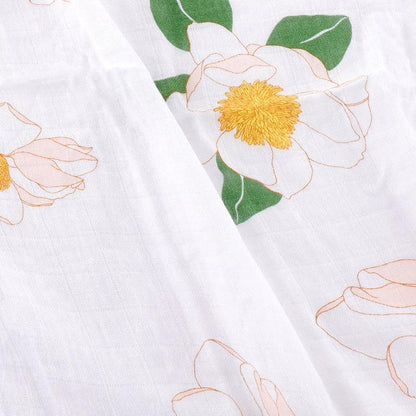 Southern Magnolia baby muslin swaddle blanket and burp cloth set, featuring delicate floral patterns in soft pastels.