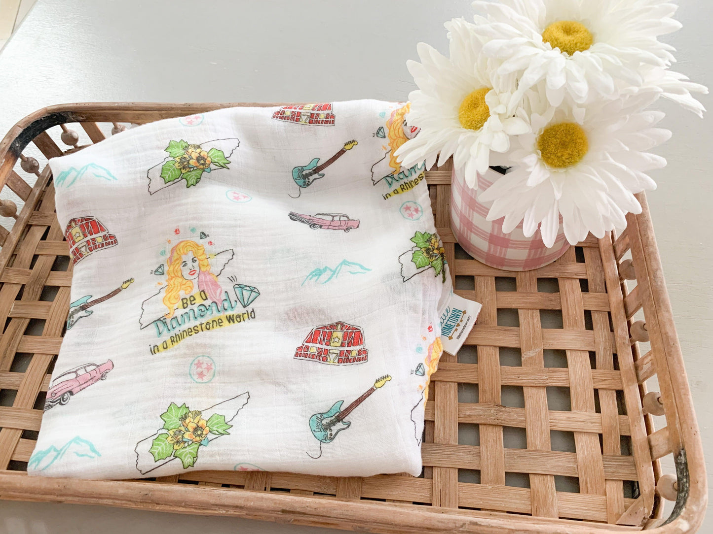 Floral muslin swaddle blanket and burp cloth set with "Tennessee Baby" text, featuring delicate pink and green flowers.