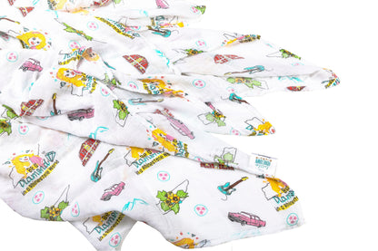 Floral-themed muslin swaddle blanket and burp cloth set with "Tennessee Baby" text, neatly folded on a white background.