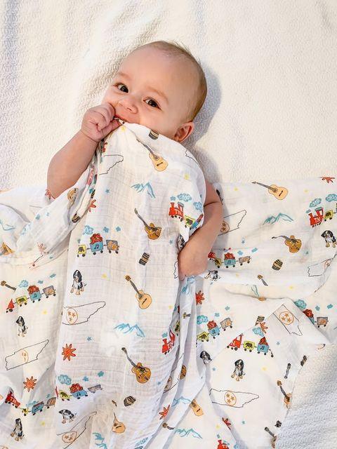 Tennessee-themed baby gift set with muslin swaddle blanket and burp cloth/bib combo, featuring state icons.