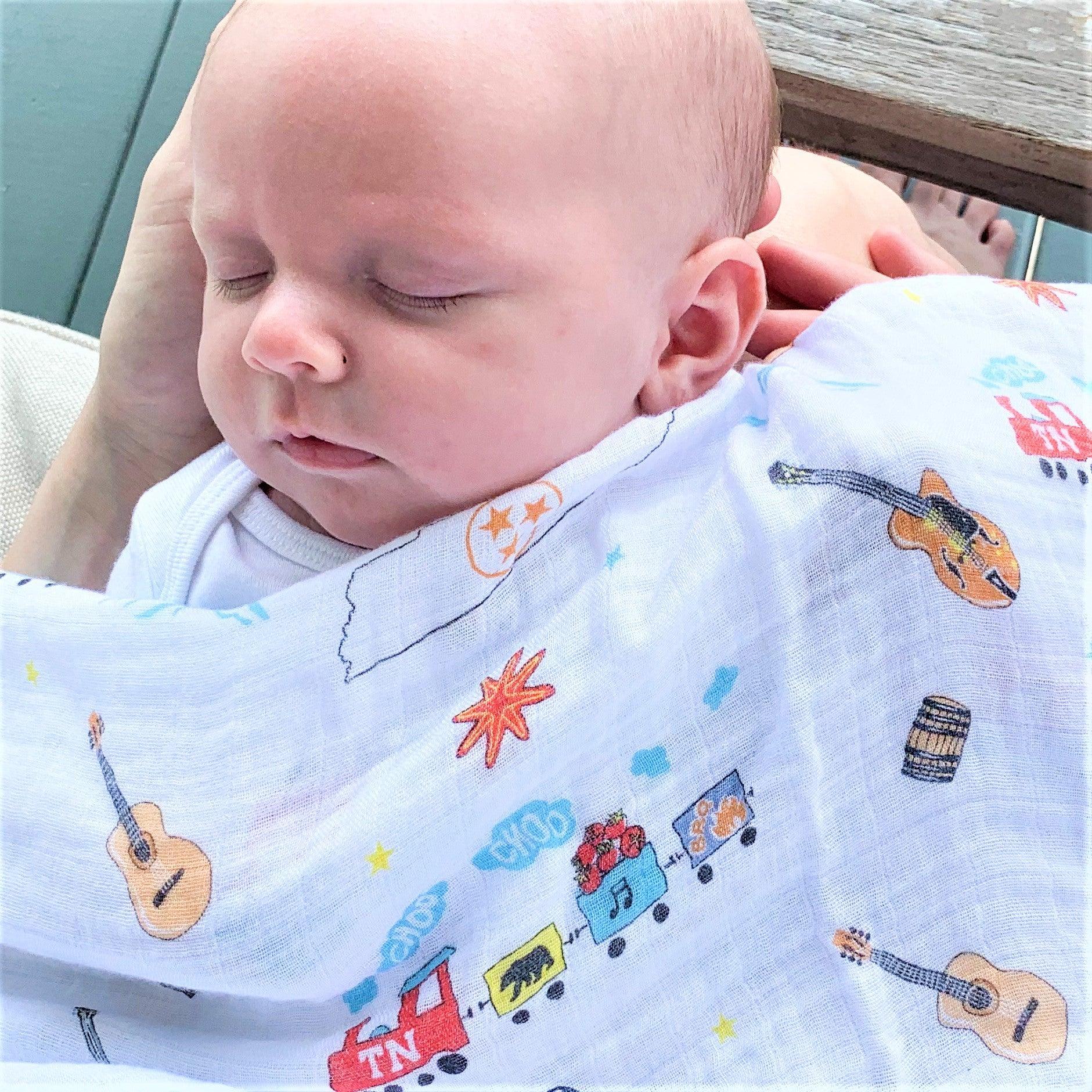 Tennessee-themed baby gift set with muslin swaddle blanket and burp cloth/bib combo, featuring state icons.