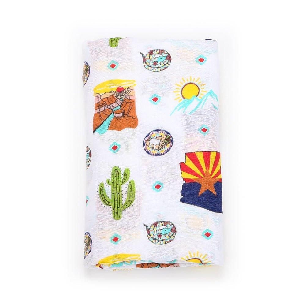 Gift set with Arizona-themed muslin swaddle blanket and burp cloth/bib combo, featuring desert motifs.