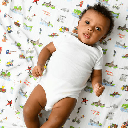 Gift set with Austin-themed baby muslin swaddle blanket and burp cloth/bib combo, featuring Texas icons.