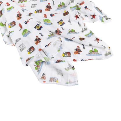 Austin-themed baby gift set with muslin swaddle blanket and burp cloth, featuring Texas icons and landmarks.