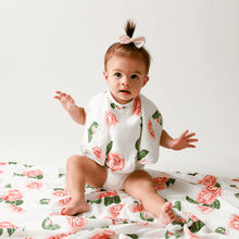 Load image into Gallery viewer, Gift set with a Camelia baby muslin swaddle blanket and burp cloth/bib combo, featuring floral patterns.
