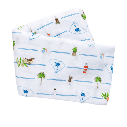 South Carolina-themed baby gift set with muslin swaddle blanket and burp cloth, featuring state icons and landmarks.