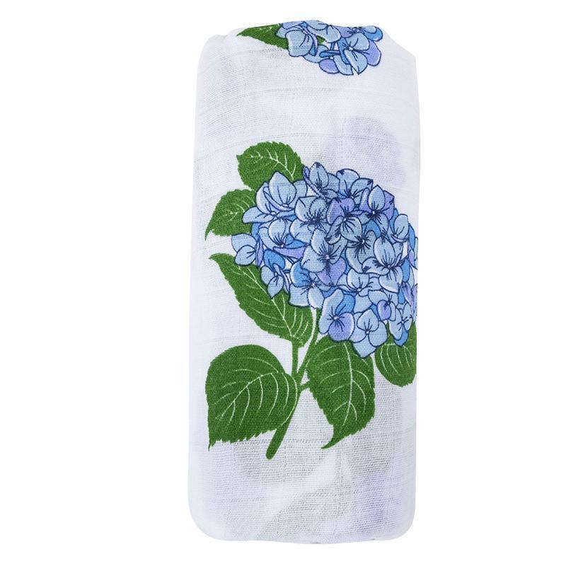 White muslin swaddle blanket adorned with delicate blue and pink hydrangea patterns, folded neatly.