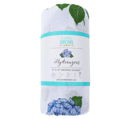 Soft muslin swaddle blanket with delicate hydrangea print in pastel blues and greens, by Little Hometown.