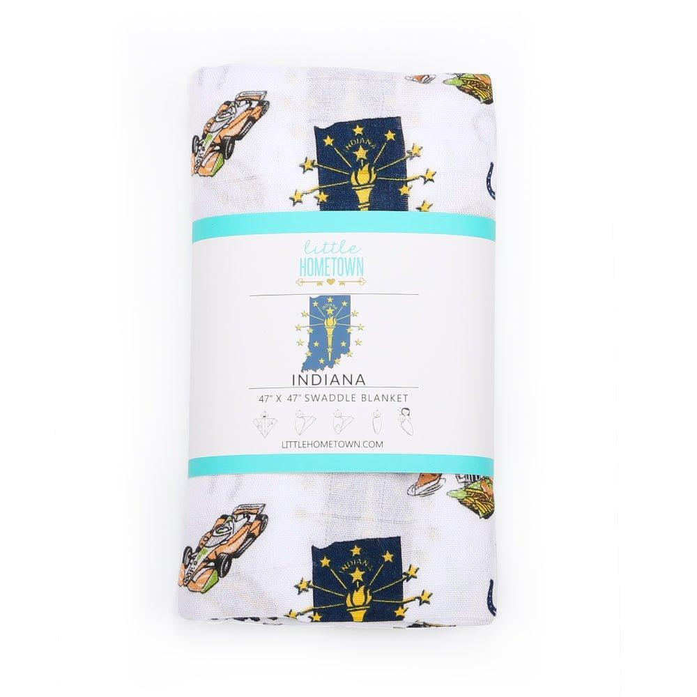 White muslin swaddle blanket with Indiana state map, featuring landmarks, animals, and "Indiana" text in blue.