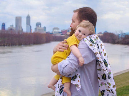 Soft muslin swaddle blanket with Indiana state map design, featuring landmarks and icons in pastel colors.