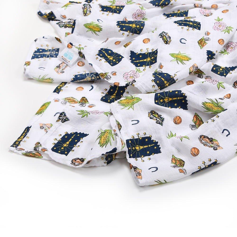 Soft muslin swaddle blanket with Indiana state map design, featuring landmarks and icons in pastel colors.