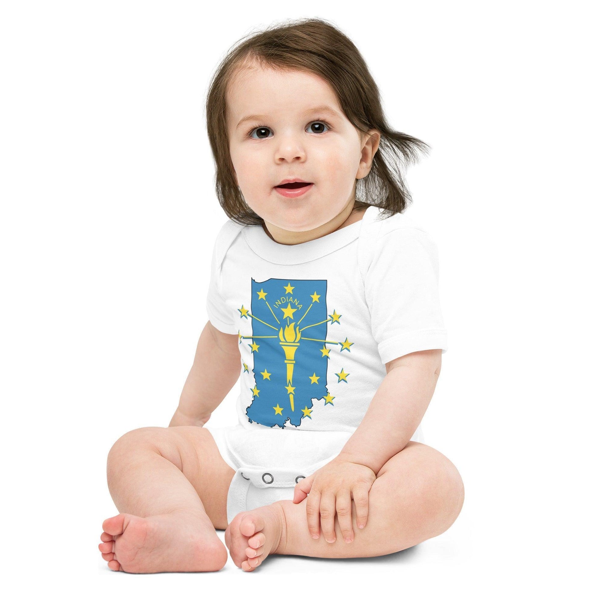 White baby onesie featuring a blue outline of Indiana state, with a yellow torch and stars and the word "Indiana" written in block letters on a plain background.