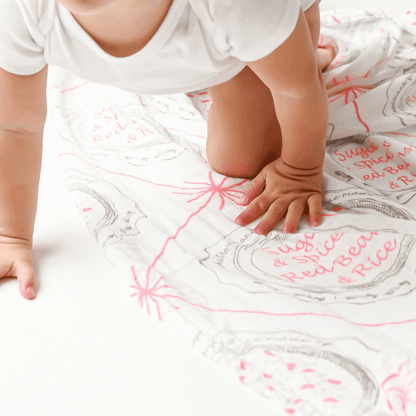 Louisiana-themed baby girl muslin swaddle blanket with pink and white design, featuring state icons and "Louisiana" text.