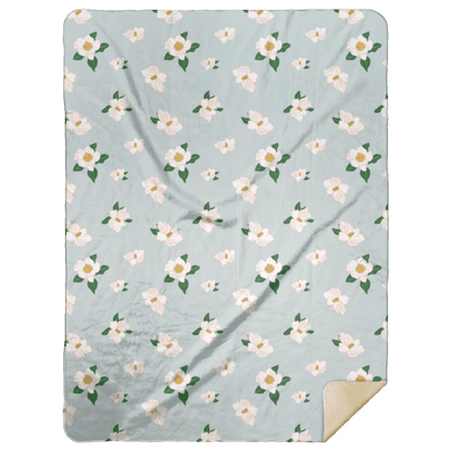 Soft, cozy throw blanket with magnolia flower design in pastel colors, measuring 60x80 inches.