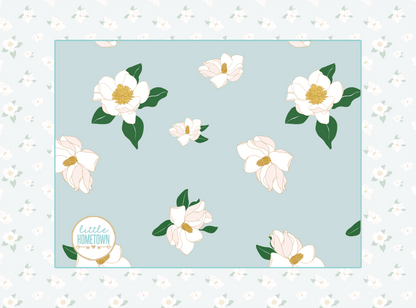 Soft, plush throw blanket with a magnolia flower pattern in pastel colors, measuring 60x80 inches.