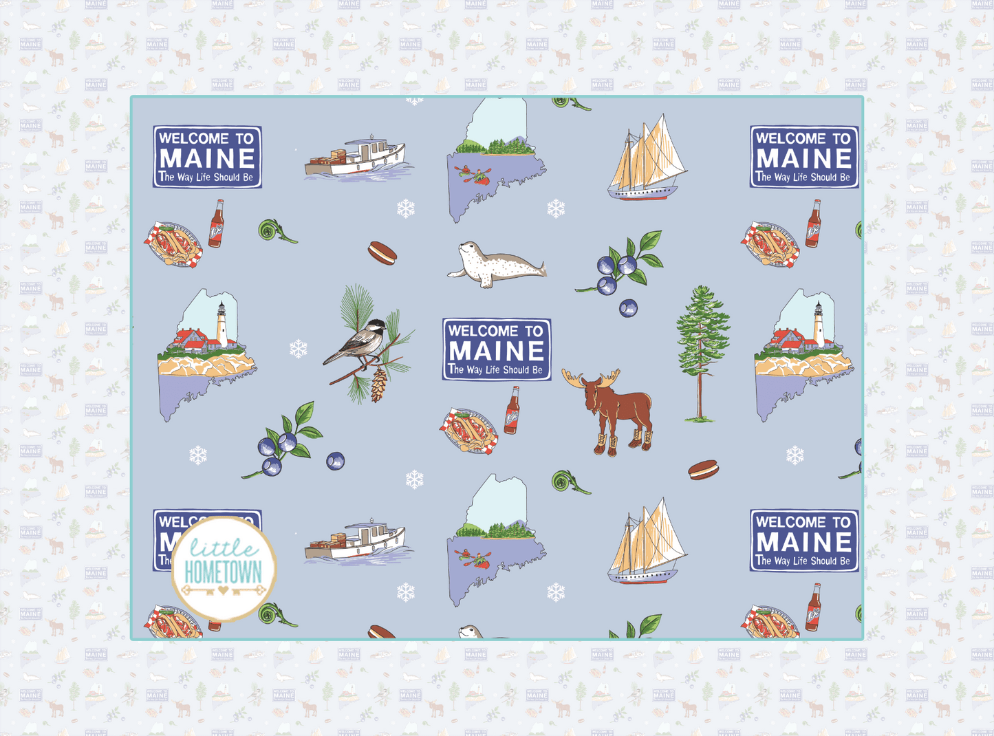 Colorful plush throw blanket featuring a map of Maine, Welcome to Maine sign, moose, blueberries, and other landmarks, animals, and vibrant illustrations.