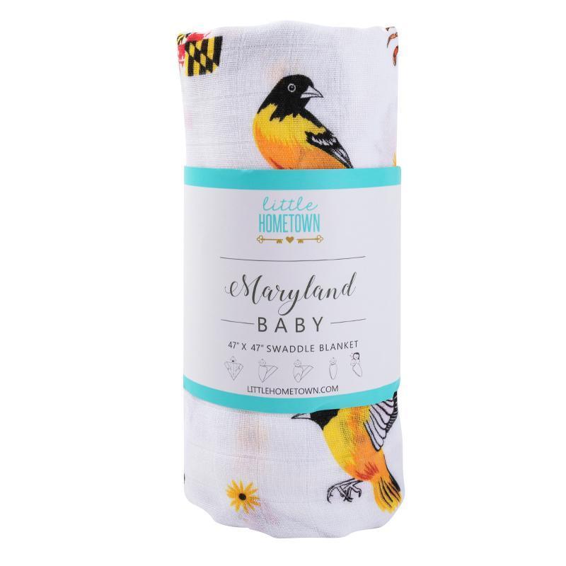 White muslin baby swaddle blanket with Maryland-themed illustrations, including crabs, lighthouses, and state symbols.