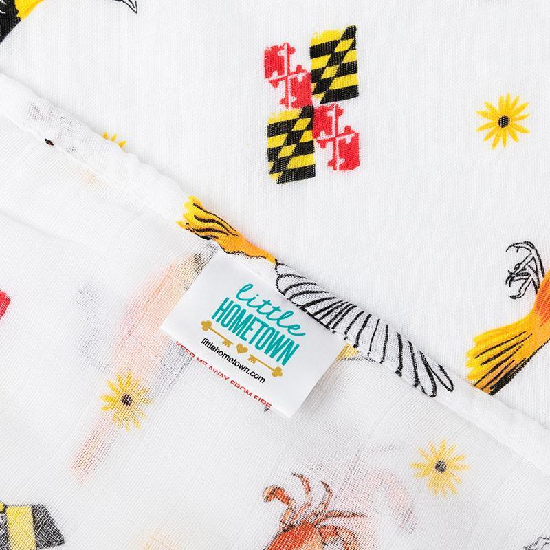 Maryland-themed baby muslin swaddle blanket with state icons like crabs, flags, and lighthouses on a white background.