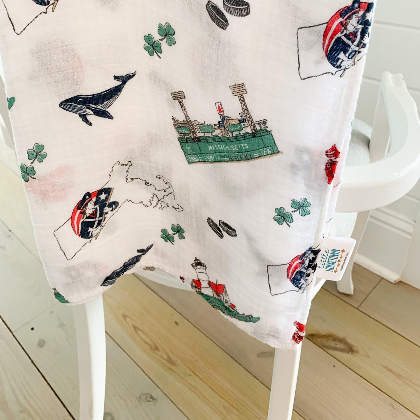 Massachusetts-themed baby muslin swaddle blanket with state icons like lobsters, lighthouses, and sailboats.