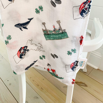 Massachusetts-themed baby muslin swaddle blanket with state icons like lobsters, lighthouses, and sailboats.