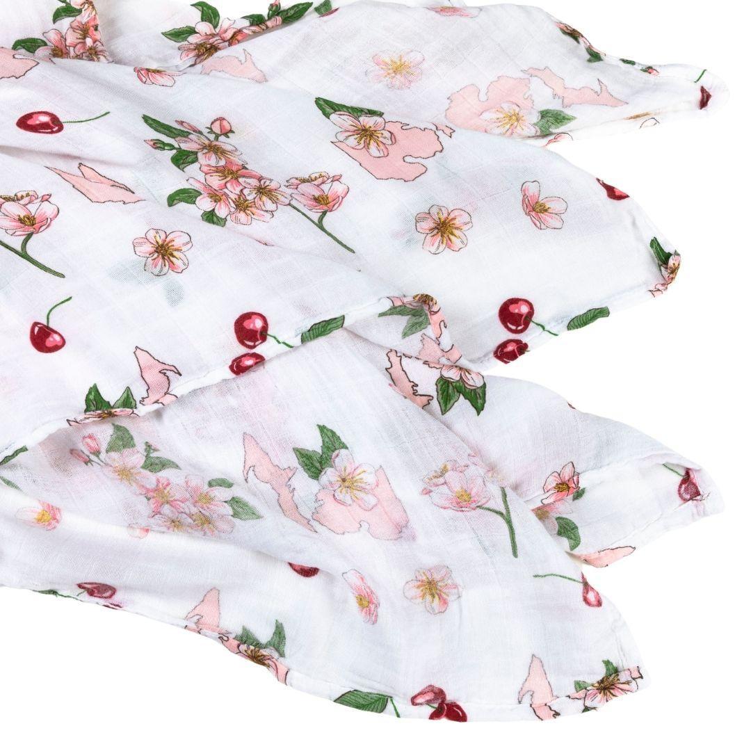 White muslin baby swaddle blanket with colorful floral Michigan state design, featuring pink, blue, and green flowers.