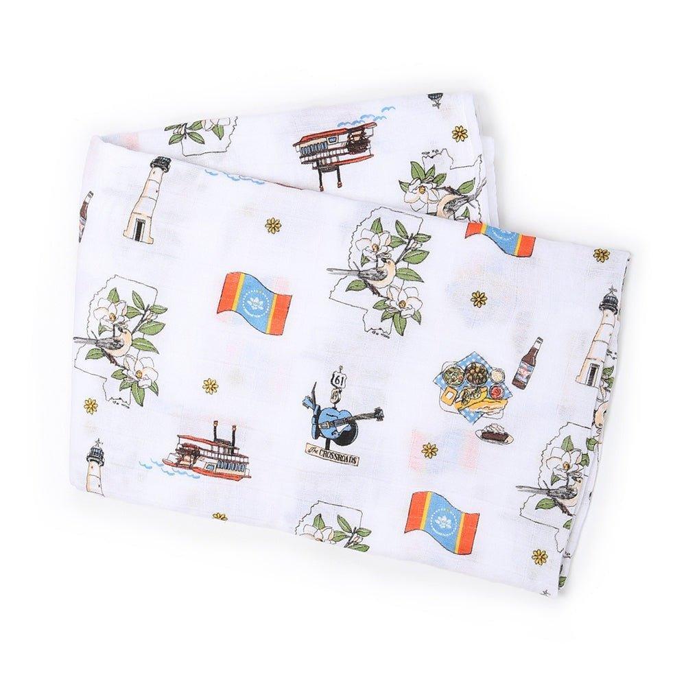 White muslin baby swaddle blanket with a colorful Mississippi map, featuring landmarks and playful illustrations.
