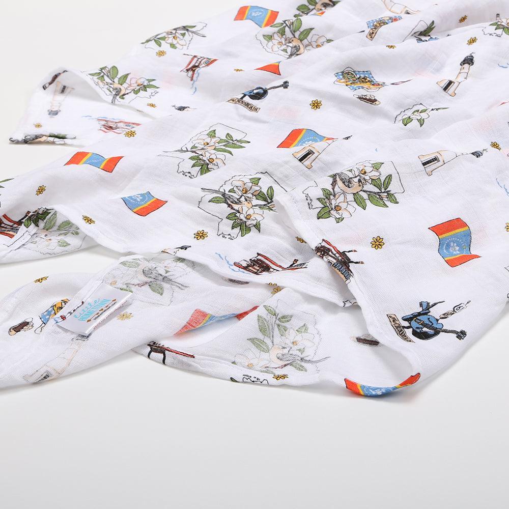 Soft muslin baby swaddle blanket featuring a colorful map of Mississippi with landmarks and playful illustrations.