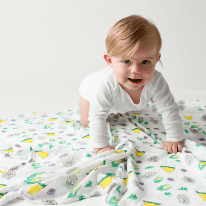 White muslin baby blanket with Illinois state map, featuring landmarks, animals, and "Illinois" text in blue.